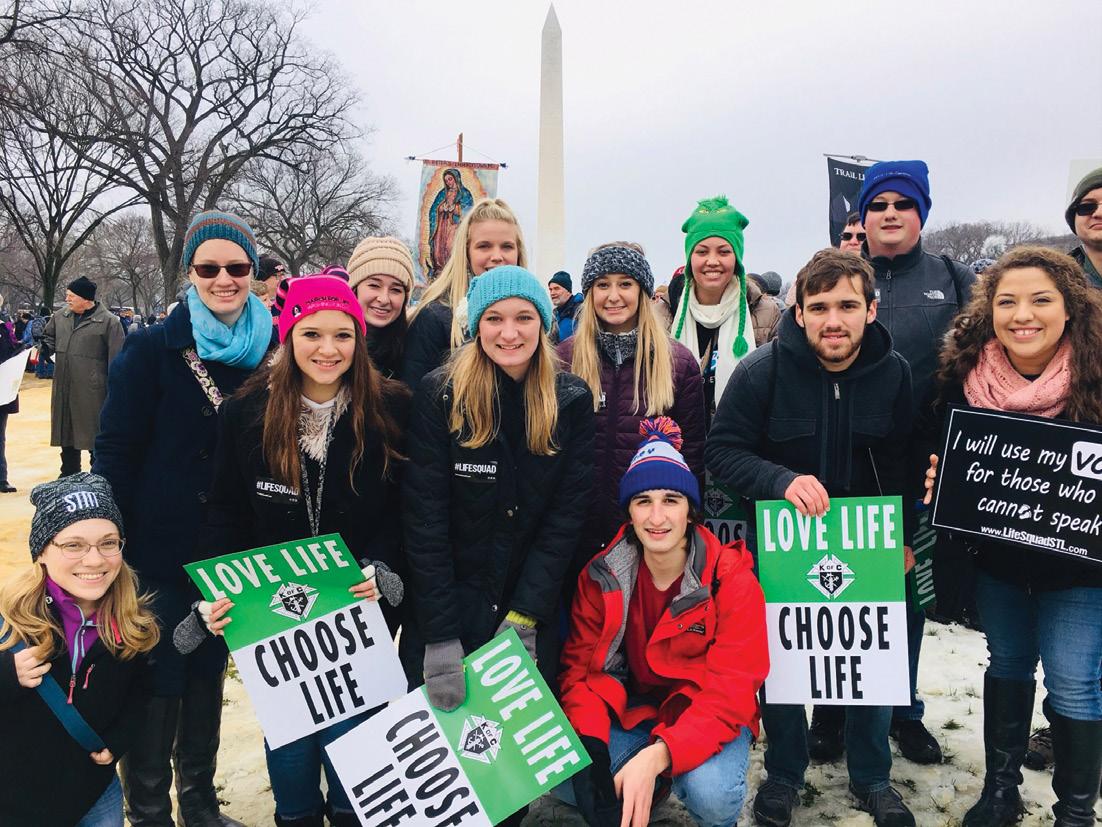 David (center, red coat) and Lydia Spillman (center, blue hat) gather with members of Quincy University, who traveled to Washington, D.C. to participate in the January 2019 March for Life.