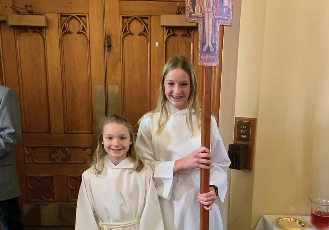 Altar server Allie Vranjes with her younger sister, Mia